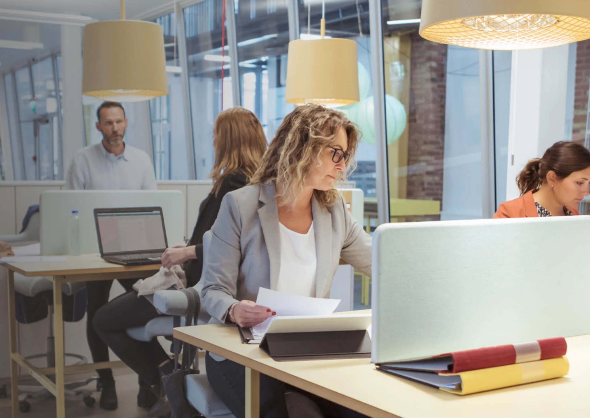 Several people working in a open office