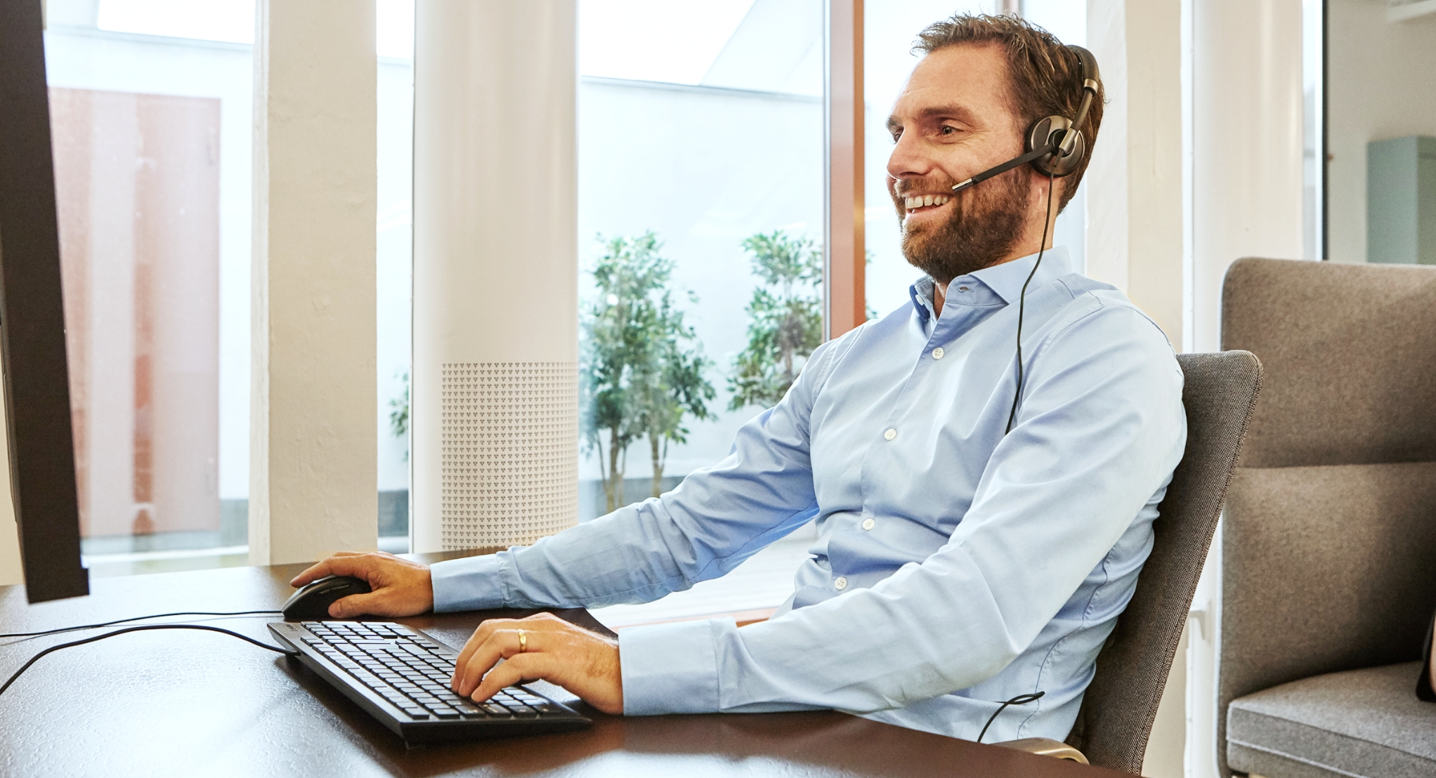 Customer service rep at his desk