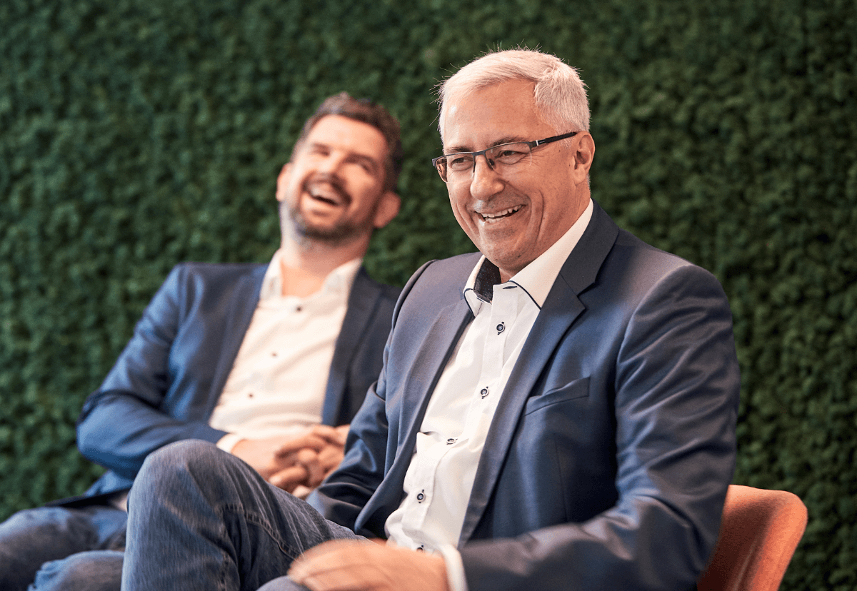 Photo of two men in suits chatting outside